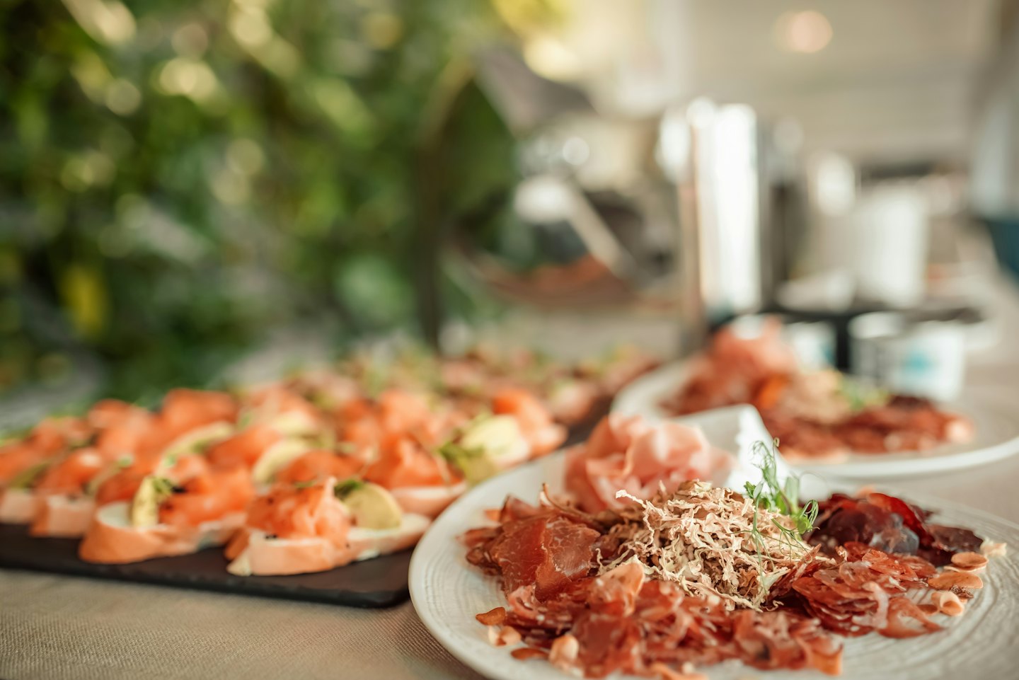 Una mesa cargada de embutidos y bruschetta de salmón para una fiesta.